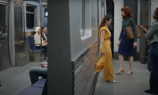 Britt Lower as Helly getting onto a train in the Apple Event video