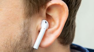 airpods 2 earbud worn in man's ear