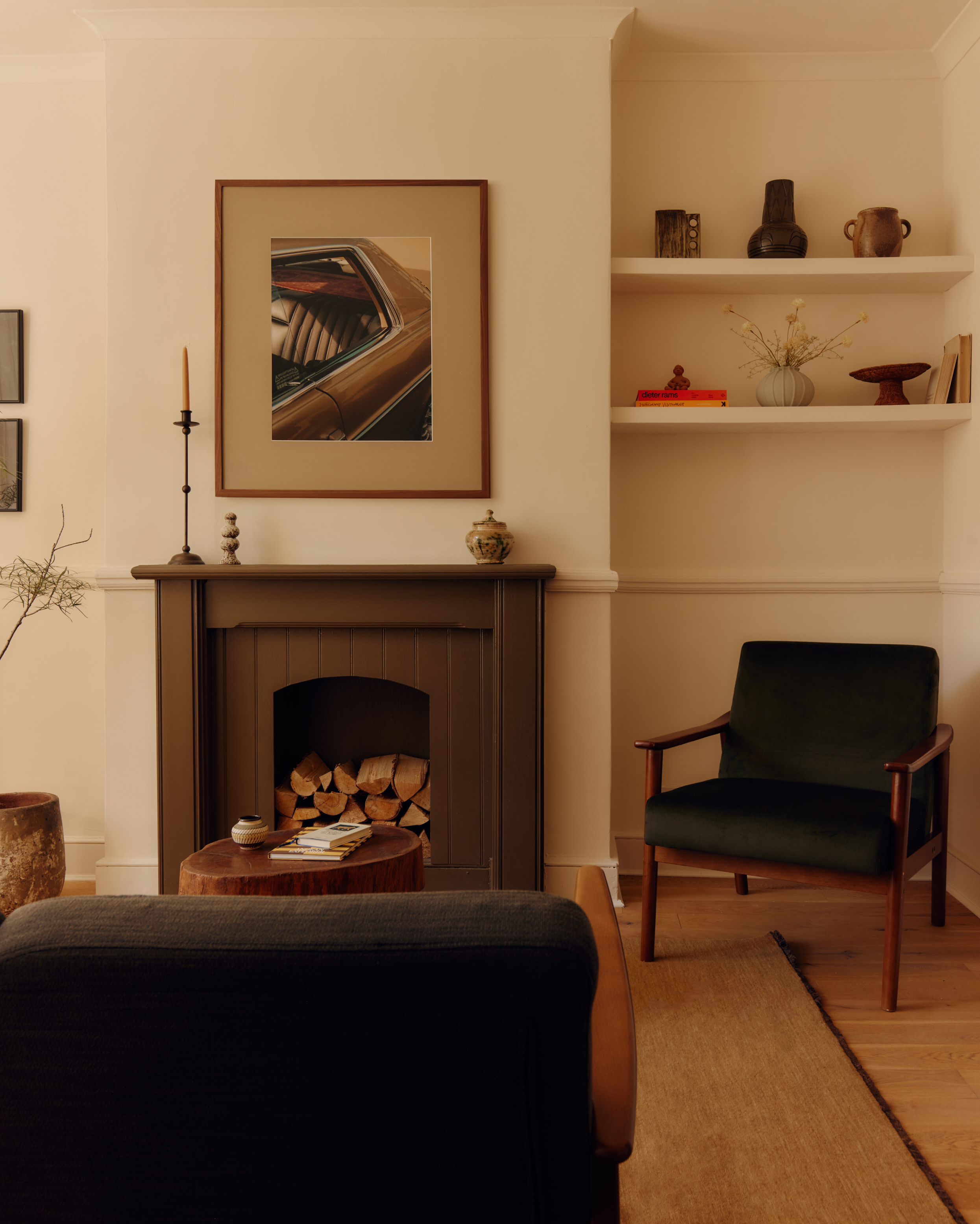 a white living room with a painted fireplace and accessories on shelves