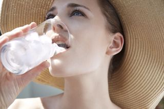 When does morning sickness start illustrated by woman drinking water