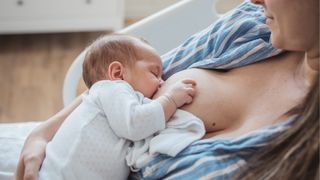 Cluster feeding isn't a thing illustrated by mom breastfeeding infant