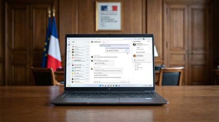 Microsoft Teams running on a Windows 11 laptop in a mockup of a French government office. 