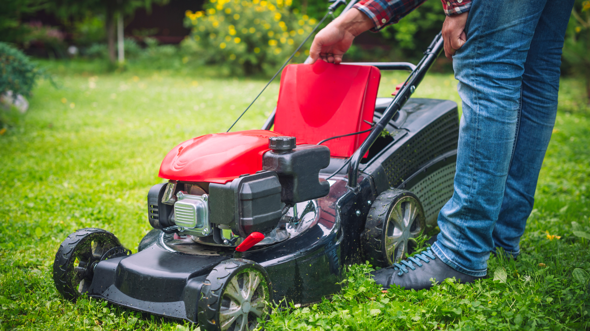 man looking at lawn mower