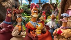 A bunch of chickens gather around a newborn chick in Chicken Run: Dawn of the Nugget, one of the new Netflix movies