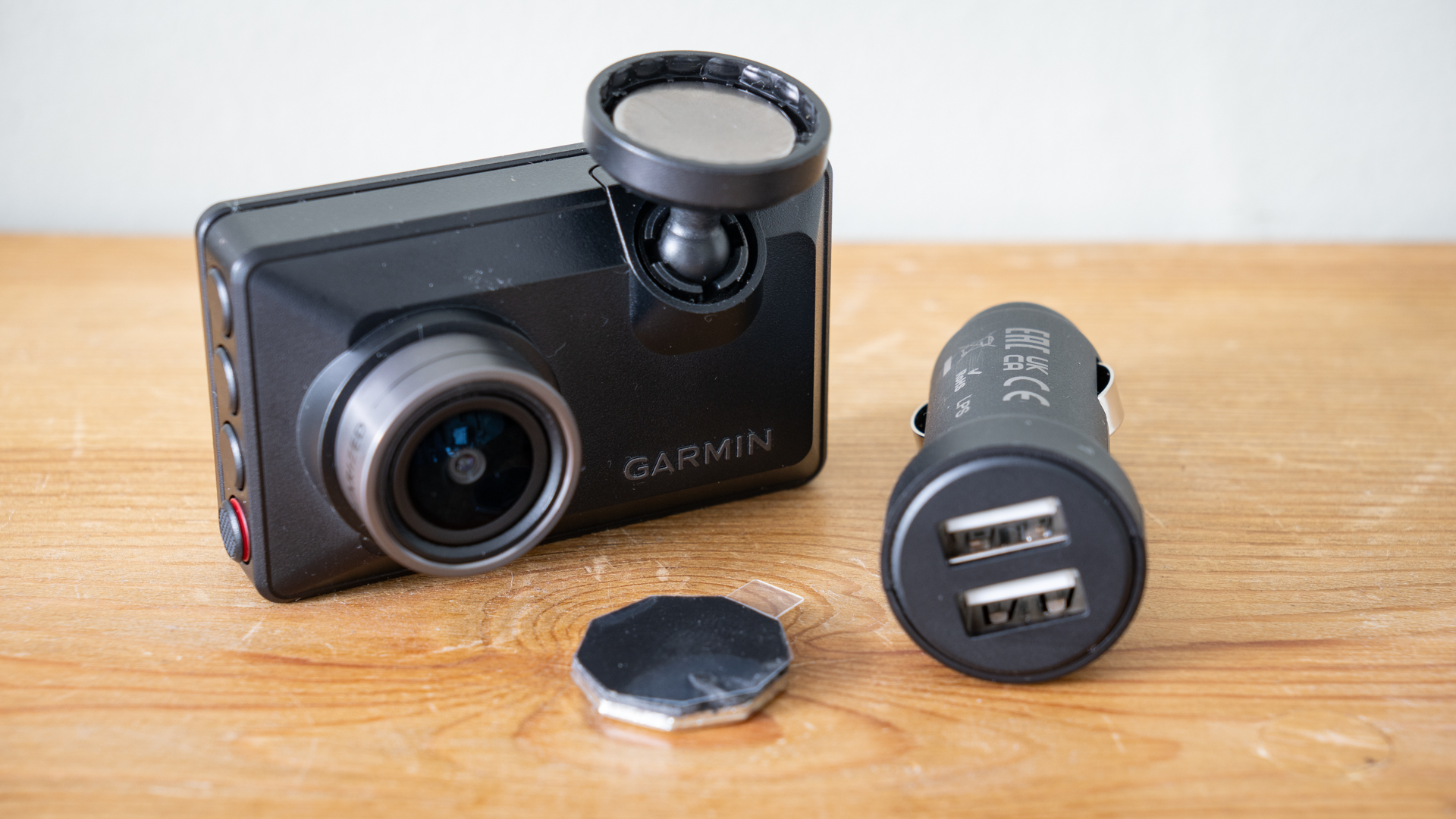 Garmin Dash Cam X210 on a wooden surface