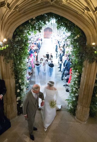 King Charles walks Meghan Markle up the aisle at her wedding to Prince Harry.