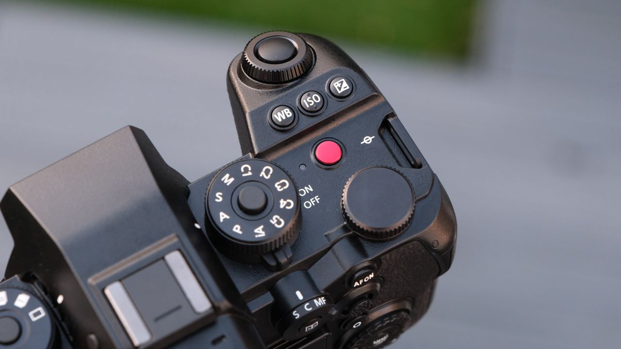 Close up of the dials and buttons on a Panasonic Lumix S1R II camera top panel