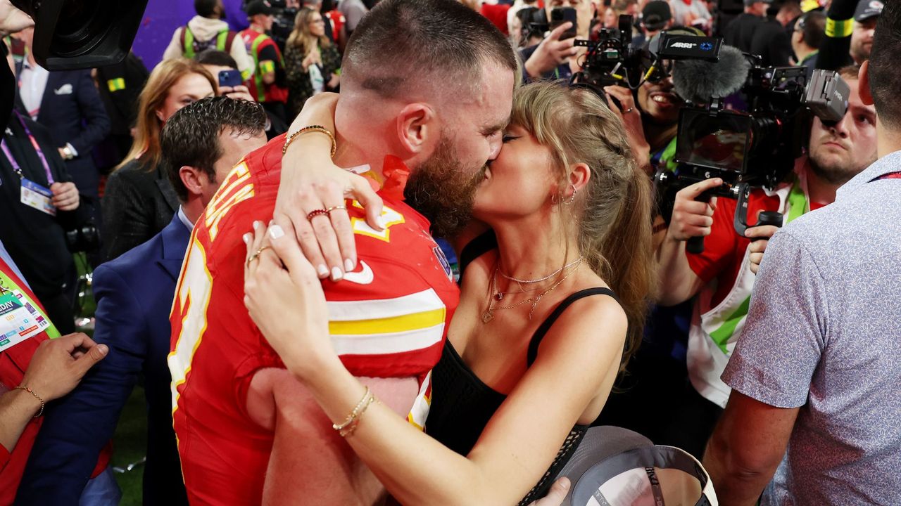 Travis Kelce and Taylor Swift kissing at the Super Bowl GettyImages-2004247308 Hero