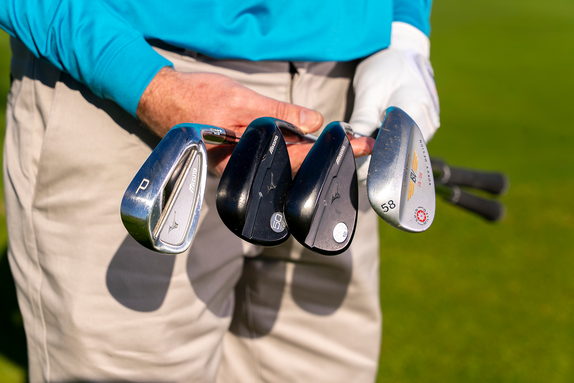 Keith Wood holding four different wedges to show how different wedges produce different flights, spin and release