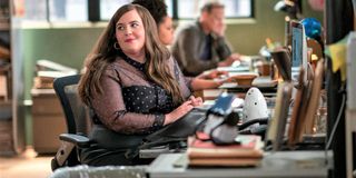 Aidy Bryant looks over her shoulder at her desk in Shrill.