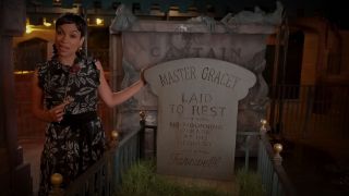 Rosario Dawson with Haunted Mansion headstone