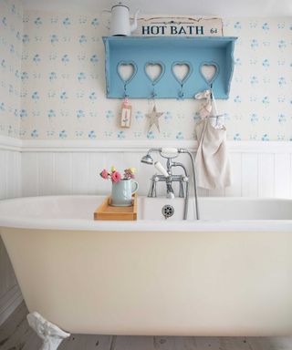 vintage style bathroom with floral wallpaper, wall panelling and roll top bath
