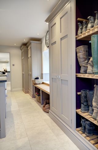 bespoke fitted bootroom with grey finish and large cupboards by lewis alderson