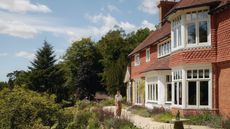 an arts and crafts style home perched atop the surrey hills