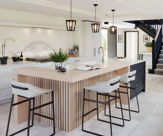 Wooden L-shaped kitchen island, white seats