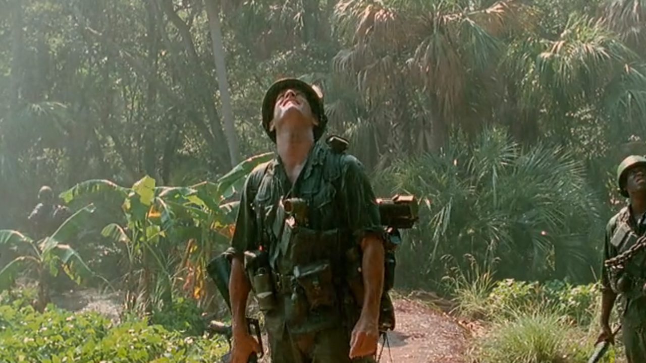 Tom Hanks, as Forrest Gump, wearing army fatigues in the jungle.