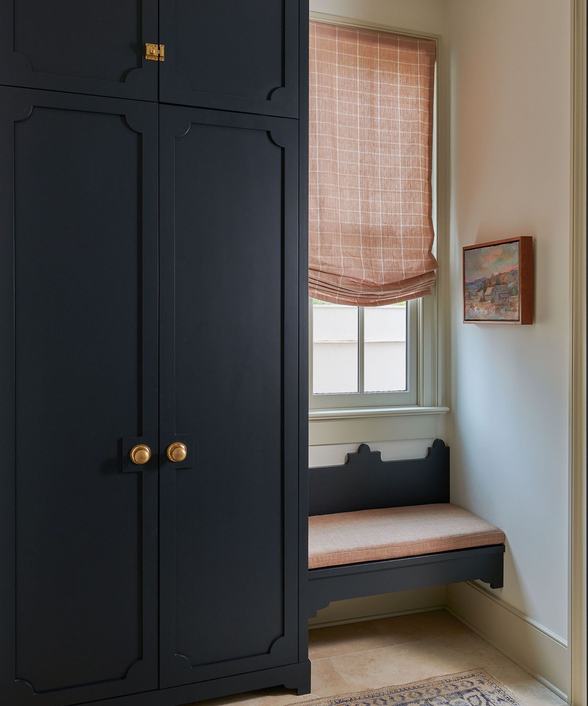 entryway with navy custom cabinetry and small seat