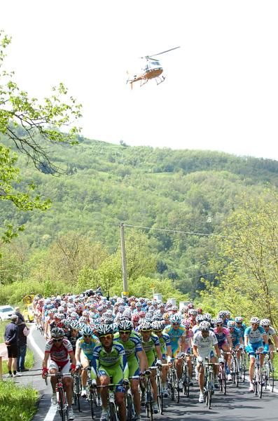 The Giro d'Italia peloton races as the helicopter TV crew covers from above.