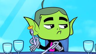 Beast Boy cutting his pizza with a fork and knife. 