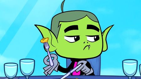 Beast Boy cutting his pizza with a fork and knife. 