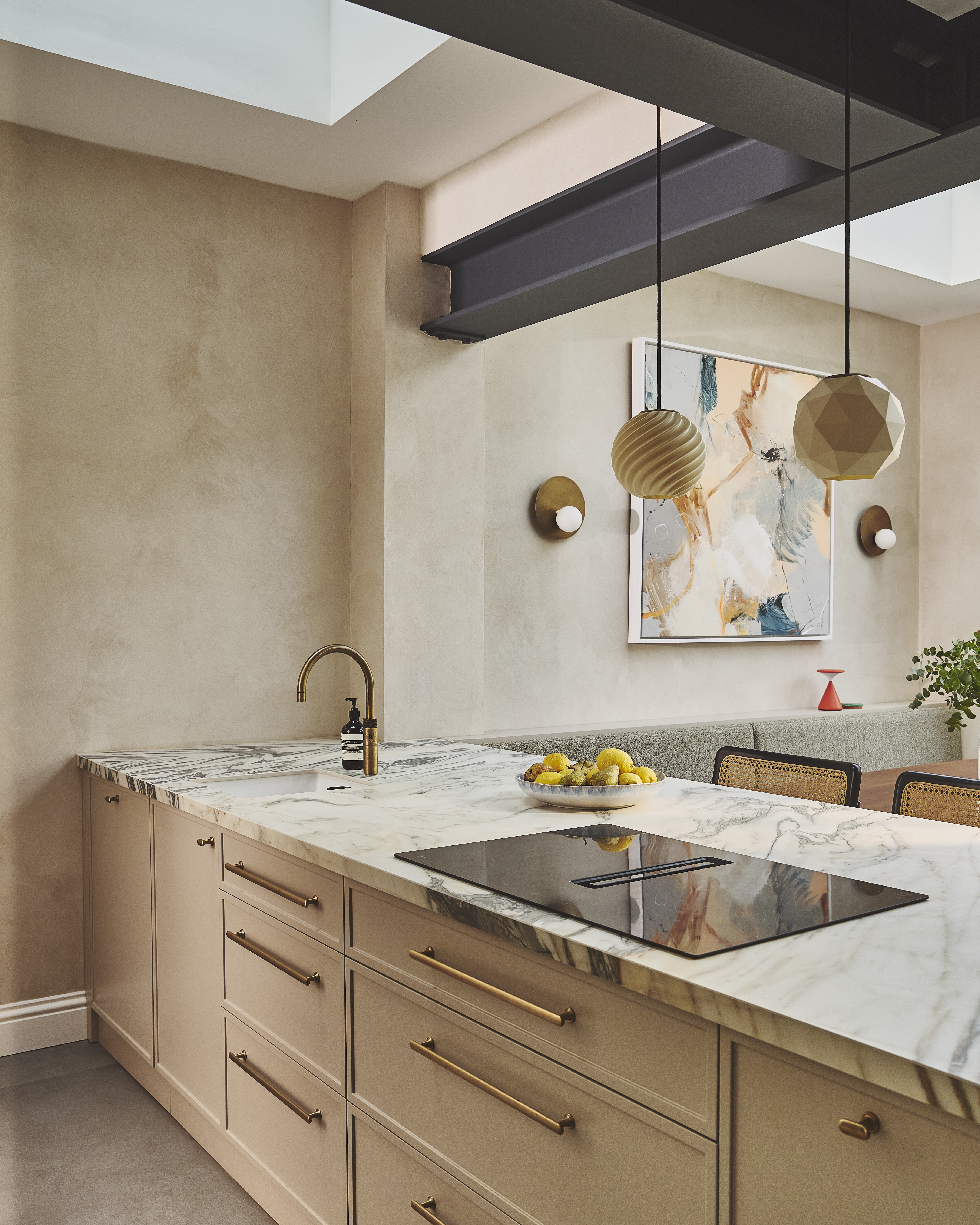 kitchen peninsula with a hob and sink integrated, above the peninsula is a skylight