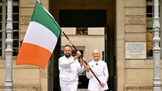 Shane Lowry (left) and 100m hurdler Sarah Lavin carry Team Ireland's flag at the Paris 2024 Olympic Games