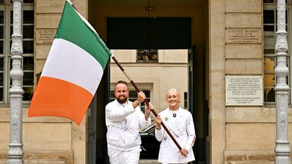 Shane Lowry (left) and 100m hurdler Sarah Lavin carry Team Ireland&#039;s flag at the Paris 2024 Olympic Games