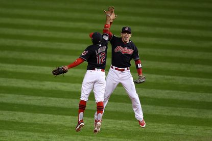 The Cleveland Indians celebrate after beating the Chicago Cubs 