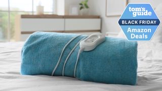 Heated blanket on a bed in airy room and Black Friday deal badge top right corner