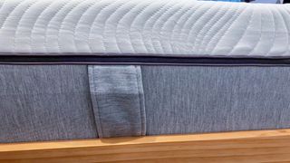 A fabric loop stitched into the side of the Emma Comfort Mattress acts as a handle