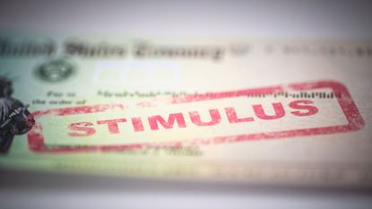 picture of blurred government check with the word "stimulus" stamped on it