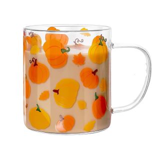 A glass mug with pumpkin decals