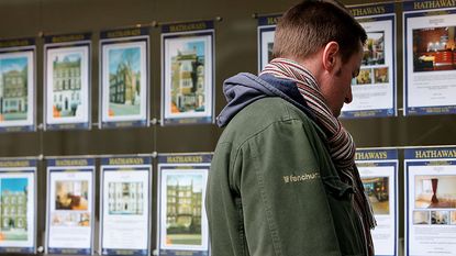 Man looking at houses for sale