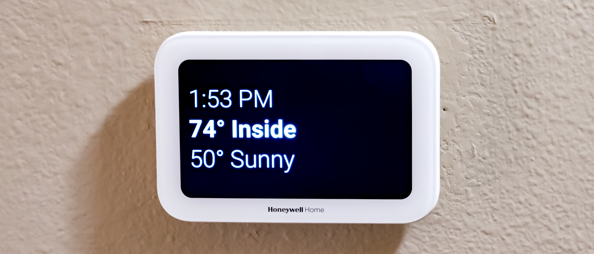 Honeywell Home X8S Smart Thermostat mounted to a hallway wall