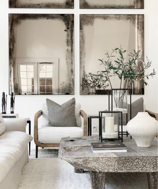 White sofa, rug, vase, chairs, wooden coffee table, tinted mirror