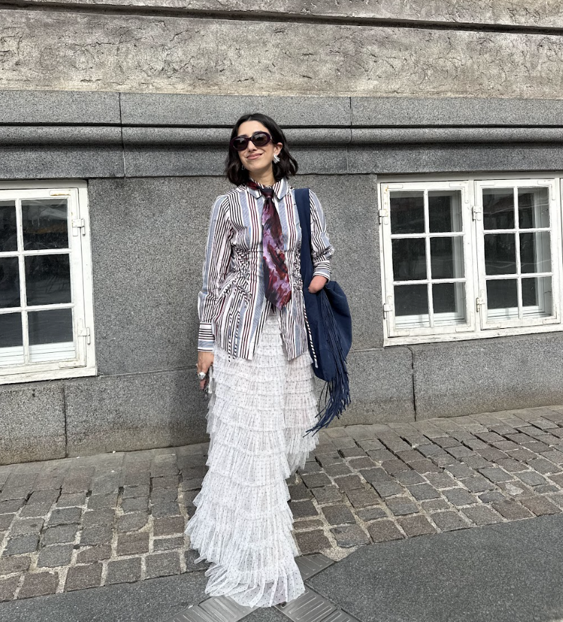 April Lockhart wears a striped shirt with a tie and tulle skirt to Copenhagen Fashion Week