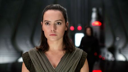 Daisy Ridley as Rey in front of an out-of-focus Kylo Ren in Star Wars: The Last Jedi