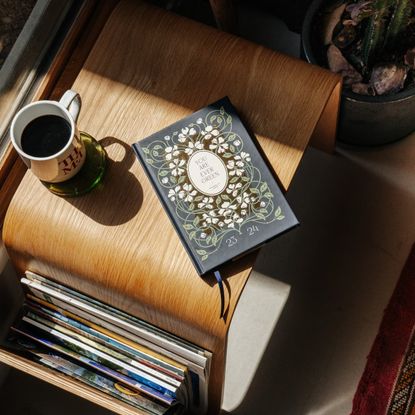 book on a table with a cup of coffee