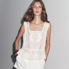 Woman in embroidered white top