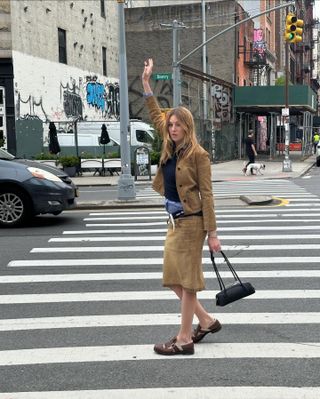 Influencer wears buckle loafers.