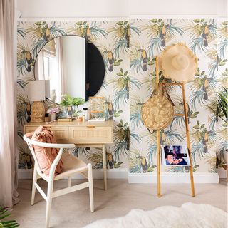 walk in dressing room with tropical wallpaper and dressing table