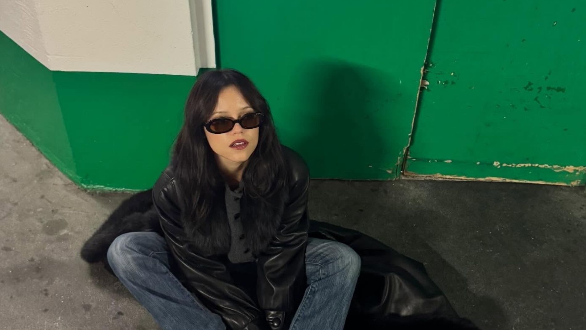 Jenna Ortega wears black Vans sneakers