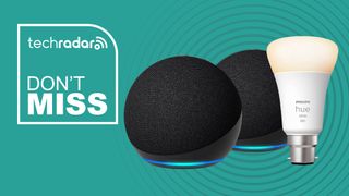 Two Amazon Echo Dot smart speakers and one Philips Hue smart light bulb on teal background with white text reading 'TechRadar Don't Miss'