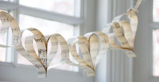 Heart-shaped paper chains made using music sheets as a creative Valentine's day decoration
