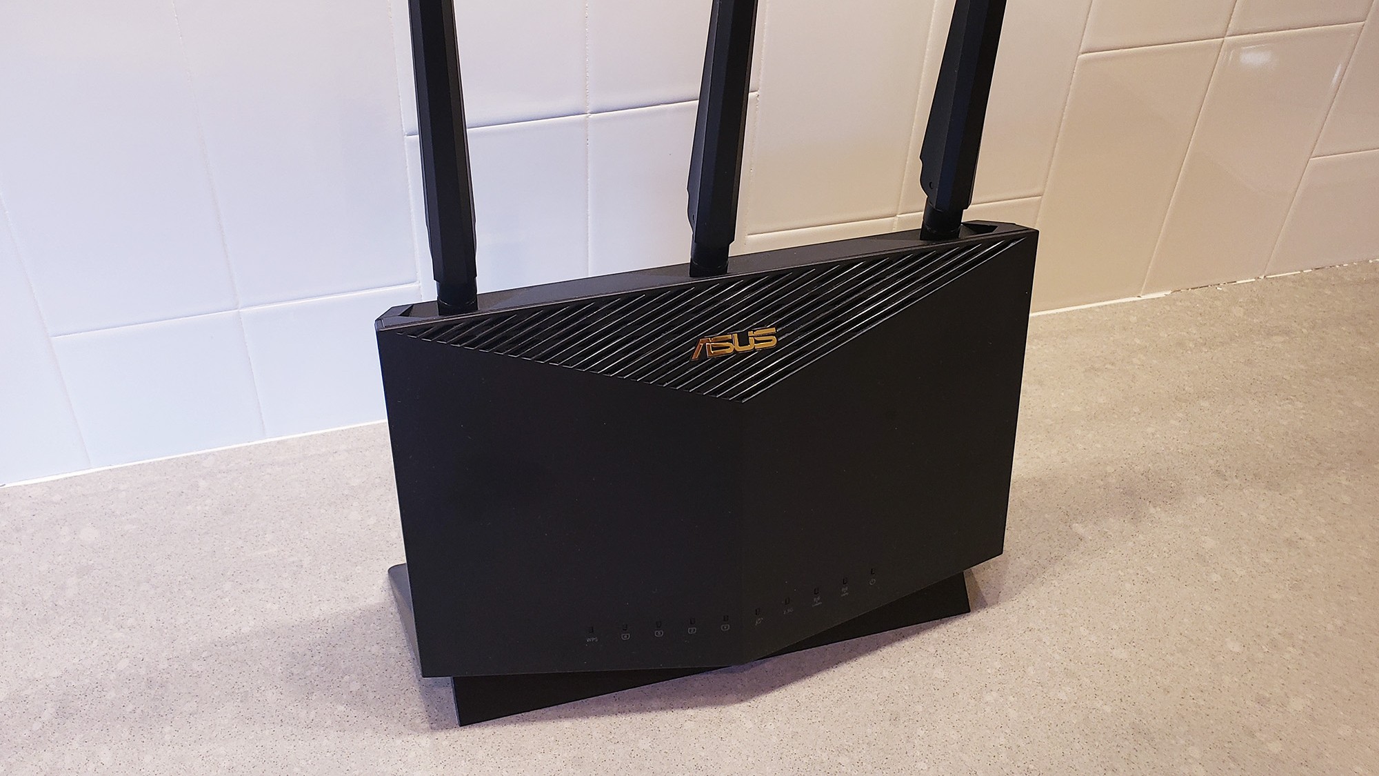 The Asus RT-AX86U router on a kitchen countertop