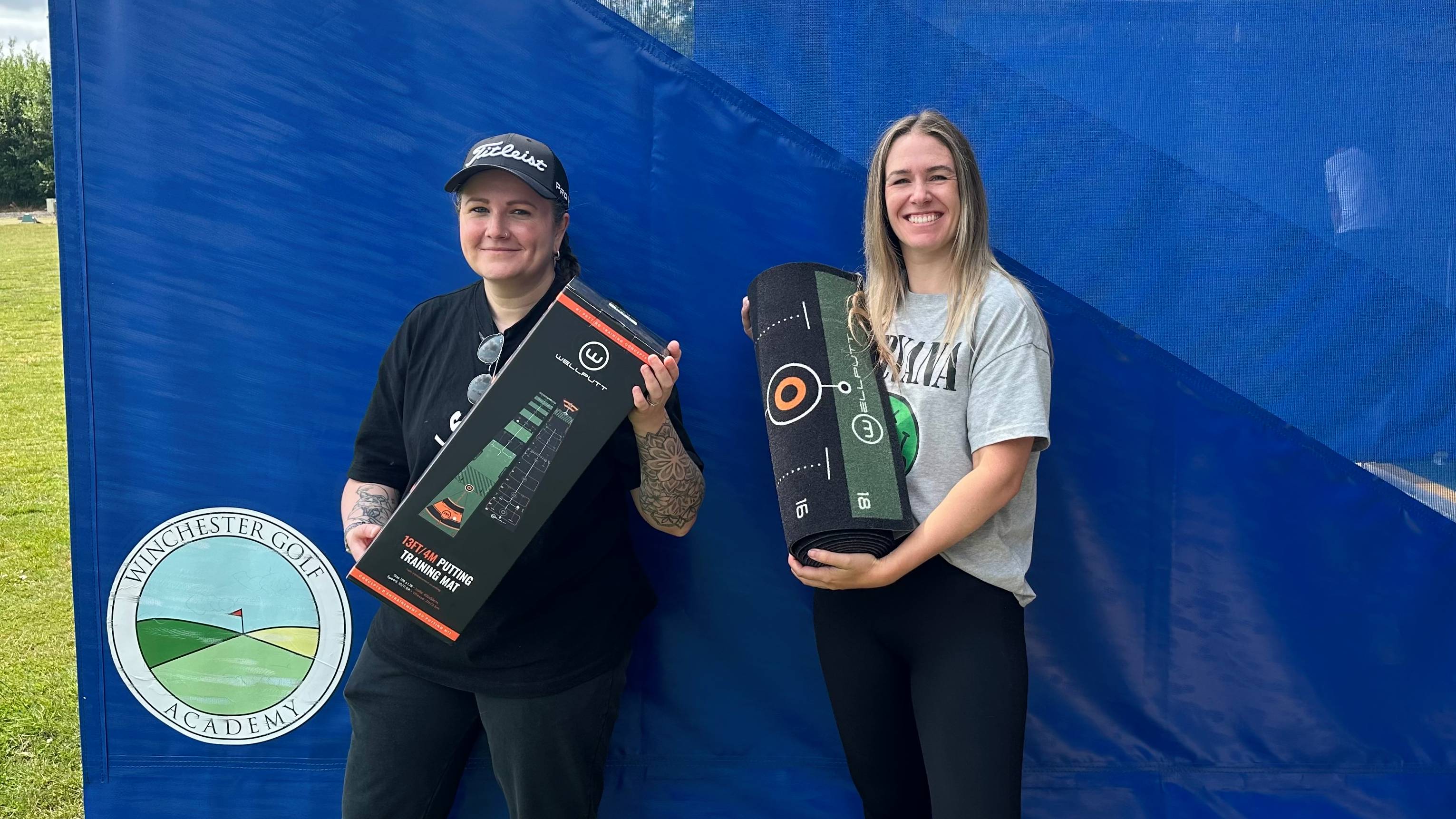 Female golfers with putting aids