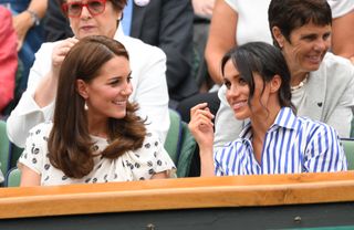 Catherine, Duchess of Cambridge and Meghan, Duchess of Sussex attend day twelve of the Wimbledon Tennis Championships
