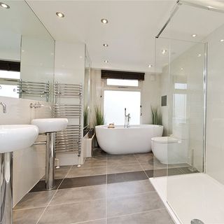 bathroom with tiles flooring and bathtub