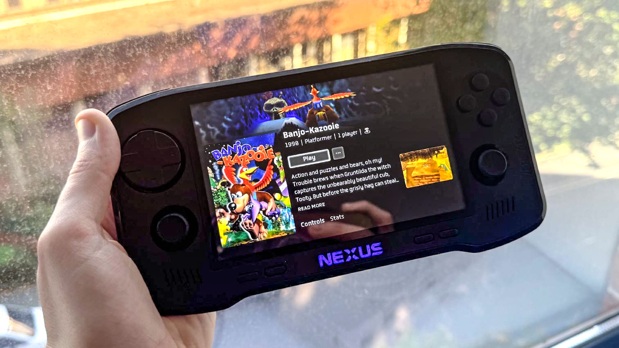 Evercade Nexus playing Banjo-Kazooie while held in hand