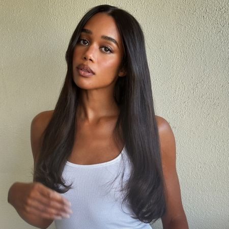 A close-up shot of Laura Harrier wearing brown lip gloss